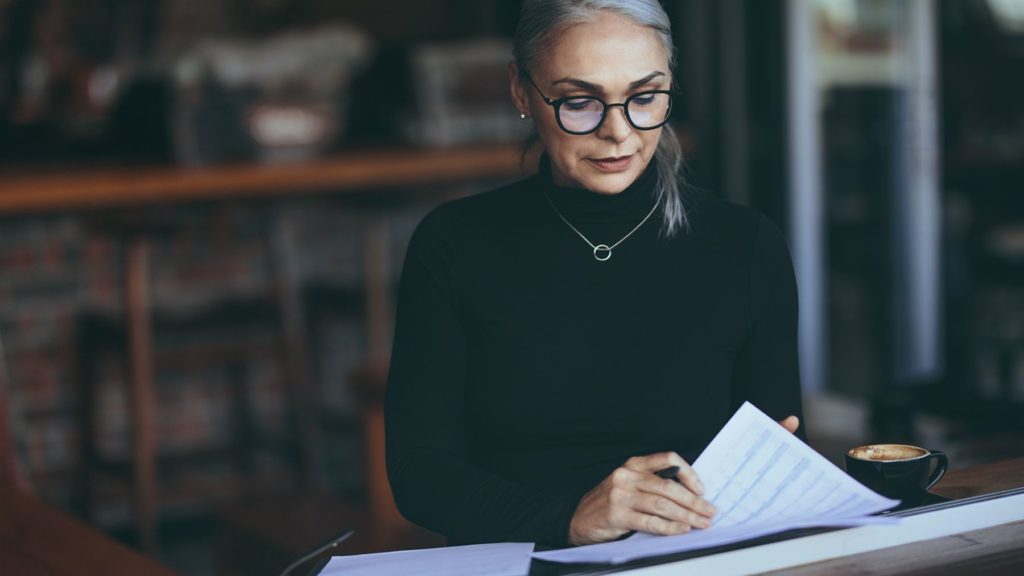 Woman reviewing financial planning documents.