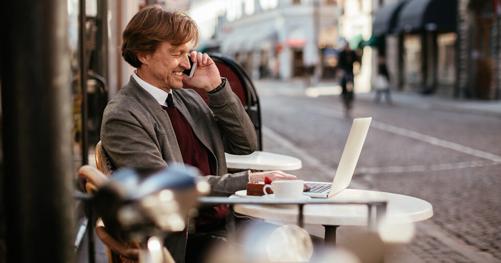 man working outside coffee shop