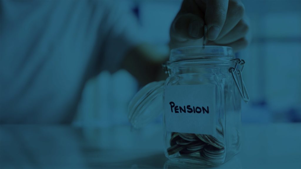 Hand putting coins in jar to save money for pension