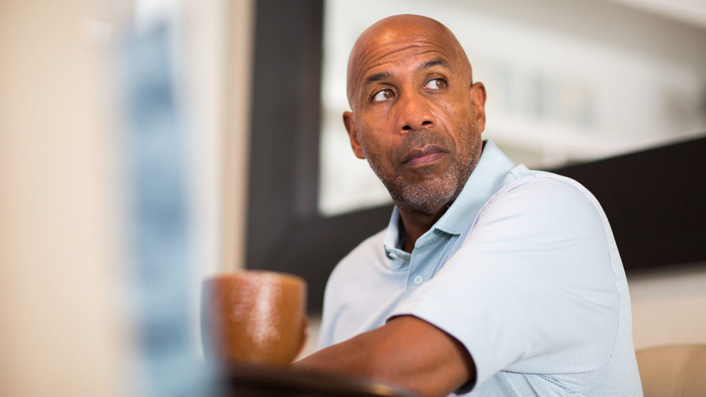 Man in a polo sits at a table