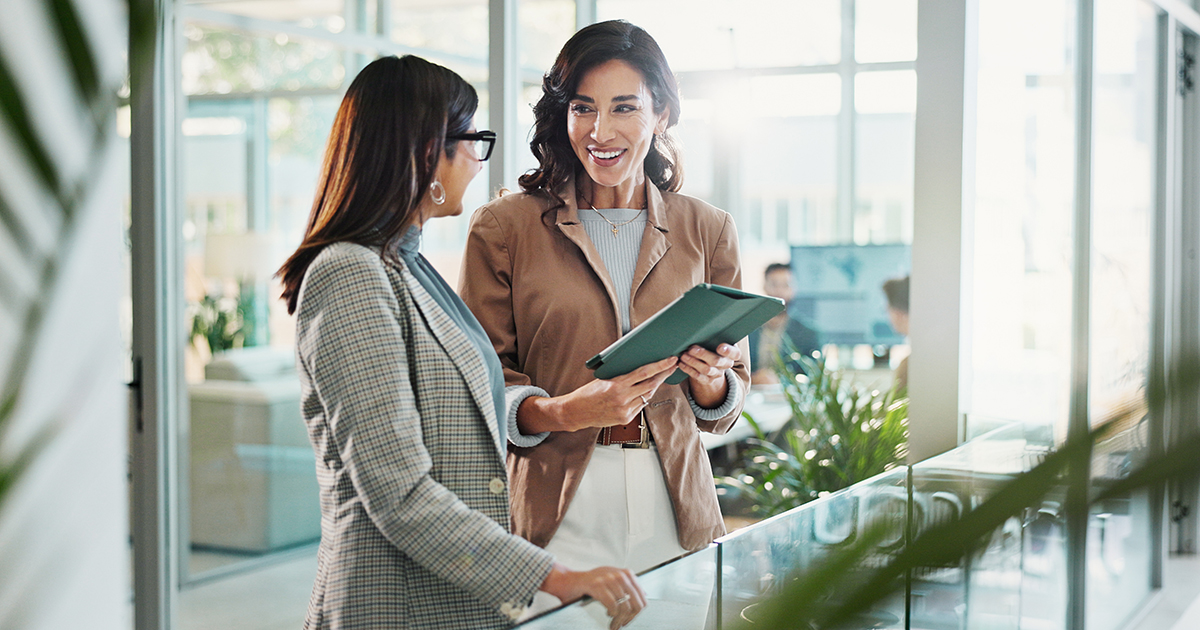 two women in an office reviewing documents