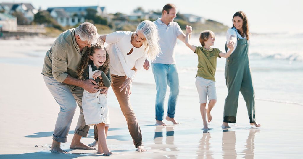Multi-generational family enjoying time together at the beach, symbolizing long-term family office investment strategies and legacy-focused wealth management