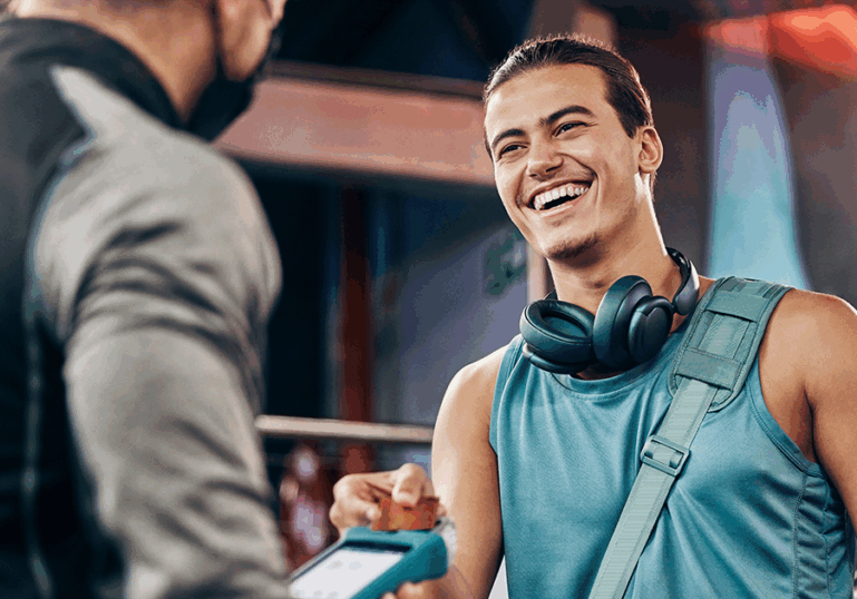 Man leaving gym and talking to a business man