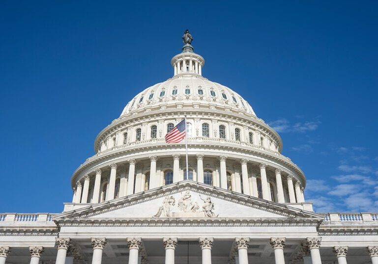 The United States Capitol dome against a clearing blue sky viewe