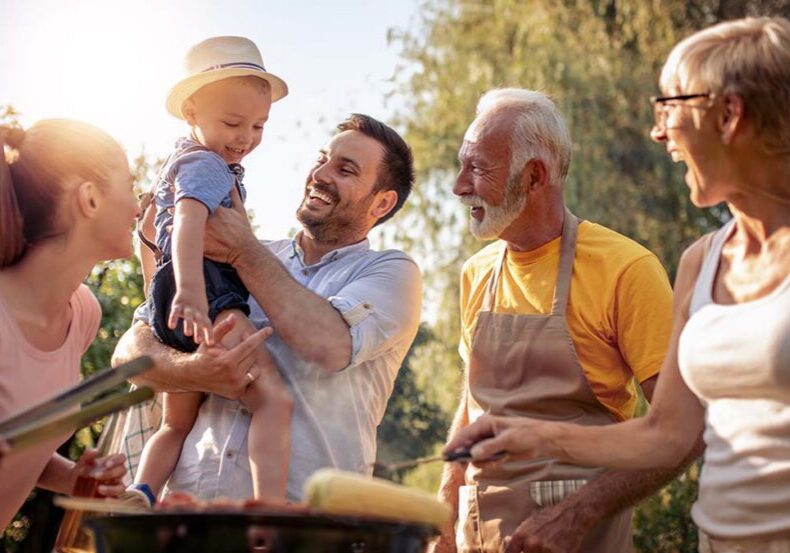 multigenerational family has relaxing summer barbecue