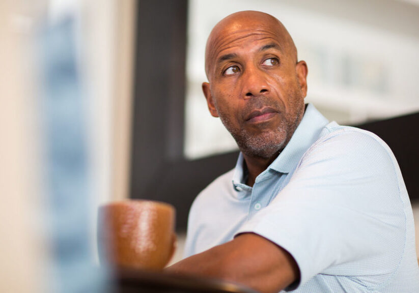 Man in a polo sits at a table