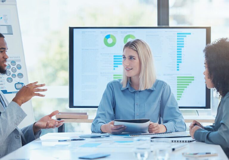 Business team going over data findings in a meeting to inform future strategies