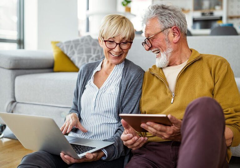 Senior couple looks up Social Security information online